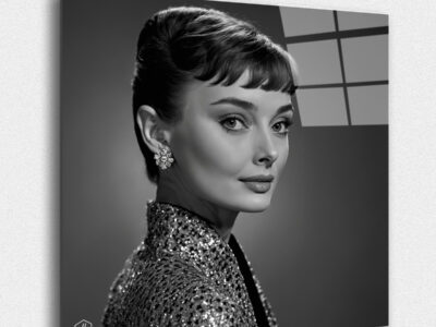 "a hyperrealistic black-and-white portrait of Audrey Hepburn in the classic Studio Harcourt style. This collection, ""Eternal Elegance: Timeless Portraits of Legendary Women,"" honors the legacy and influence of these extraordinary women, capturing their essence in the refined and timeless style of Studio Harcourt. These portraits celebrate their contributions to the world, ensuring that their memory and impact will endure for generations to come."