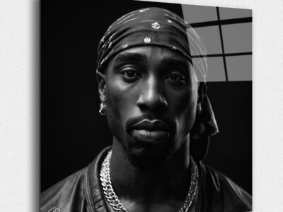 "A hyperrealistic black-and-white portrait of Tupac Shakur in the iconic Studio Harcourt style. ""Legends Never Die: Timeless Portraits of Fallen Hip-Hop Icons in Harcourt Elegance"" captures the enduring spirit and cultural impact of the most iconic figures in hip-hop history. This exclusive collection presents each legendary artist in the timeless black-and-white style of Studio Harcourt, blending their powerful presence with classic elegance. The portraits pay tribute to the creativity, resilience, and influence of these fallen icons, immortalizing their legacy with unmatched sophistication. A must-have for collectors and fans alike, this series is a celebration of the enduring power of music, culture, and the voices that continue to inspire generations."