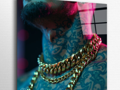 A tattooed neck buried under massive Cuban links glowing in neon.
