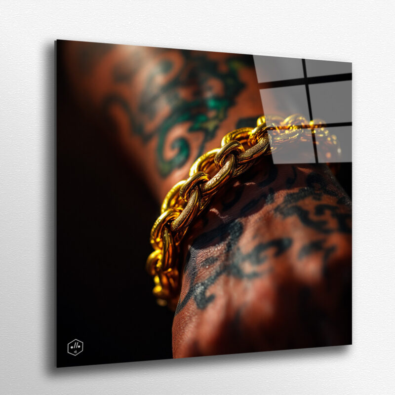 Tattooed forearm pressed with a thick gold chain, glowing under stage light.