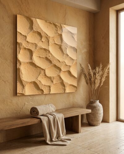 A warm field of sand-toned texture, dimpled and still, where countless grains gather into soft hollows under late, even light.
