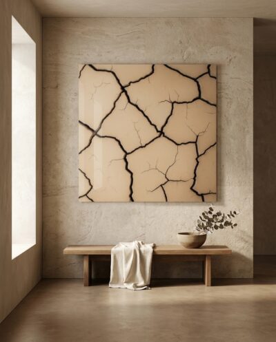 Pale clay dries into a soft mosaic, fine plates parted by crisp dark fissures that wander like rivers across a warm neutral field.