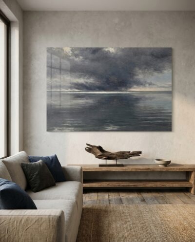 Mirror-still water reflects a heavy, brooding sky in the tense, held silence that comes just before a storm.