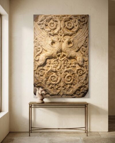 Two winged griffins rise from a scrolling acanthus tendril, carved deep enough to trap real shadow in warm honeyed marble.
