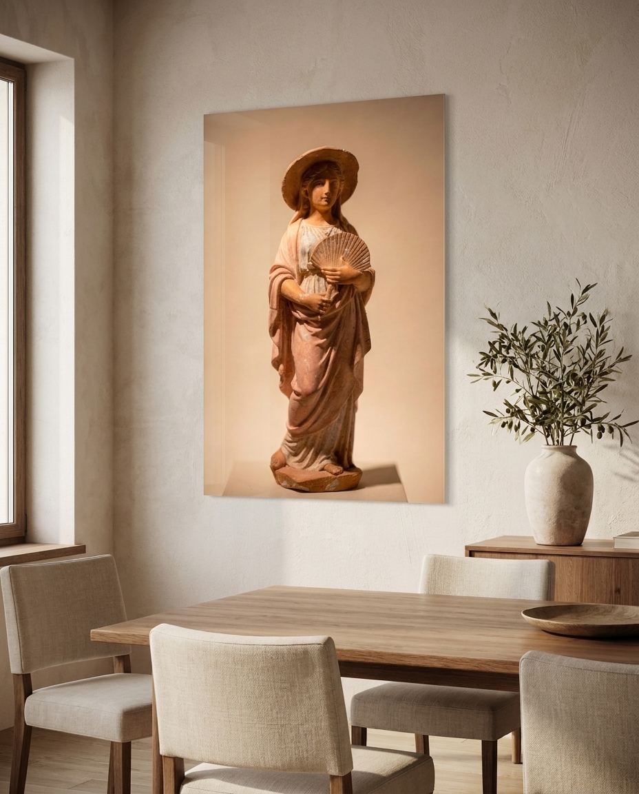 A young woman in a rose mantle and sun hat holds a small fan, a Hellenistic terracotta that found grace in an ordinary afternoon.