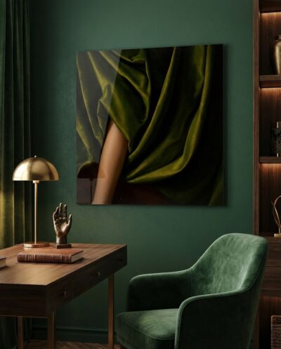 Deep olive velvet cascades in glowing folds around a bare shoulder, a quiet study in touchable luxury and warm, gathering shadow.