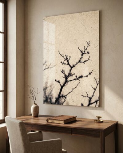 Bare branches bleed across a pale, luminous field like ink on wet paper, delicate, dark and almost weightless.