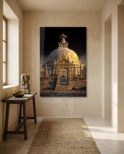 A great stupa dome rises in low golden light, its carved gateway and stone railing holding centuries of quiet devotion.