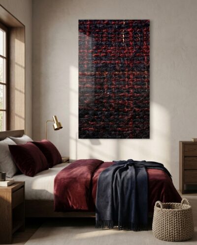 A dense hand-woven wool close-up where deep indigo crosses crimson, loose fibres catching a raking light along the threads.