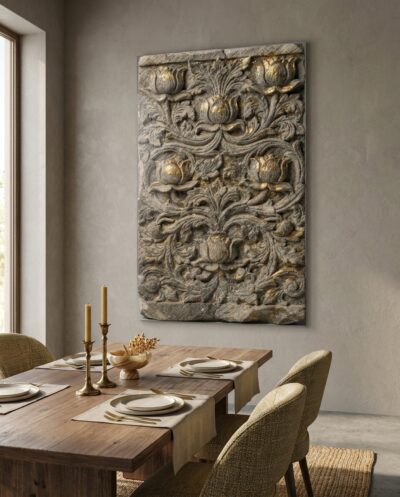 A carved stone frieze where lotus blooms and acanthus scrolls entwine, raking light drawing every petal and curl from grey schist touched with gold.