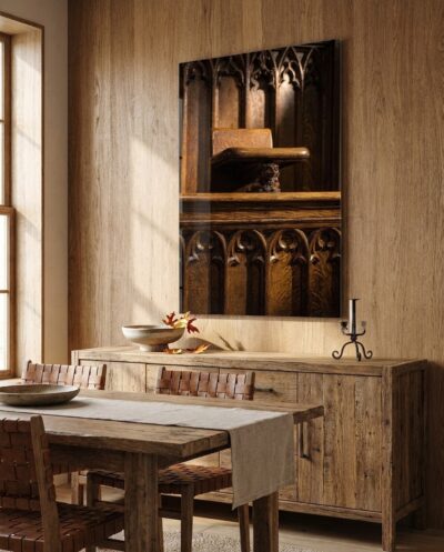 Dark, waxed oak choir stalls rise through folded panels and pierced tracery to a small grotesque hidden beneath a seat.