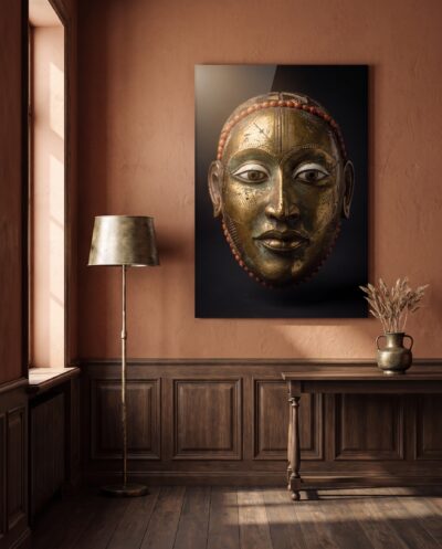 A serene golden mask, its coral-edged brow and almond eyes catching soft light against velvety darkness.