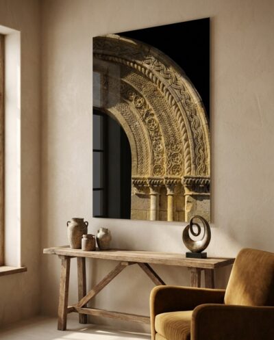 Concentric bands of chevron, rosette and interlaced cord curve through raking light across warm carved stone.