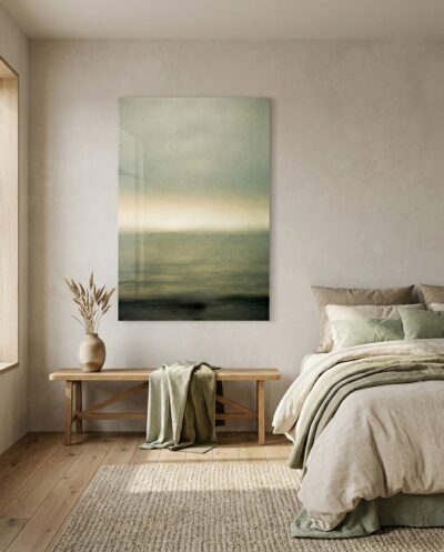 Sea and sky dissolve into one warm gradient, a soft band of gold glowing where the horizon should be, veiled in quiet grain.