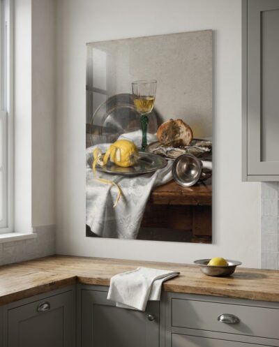 A half-peeled lemon spirals over the table's edge among pewter plates, gleaming silver and a tall glinting wine glass.