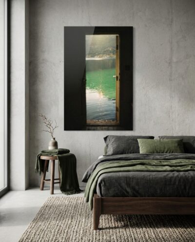 From a dark threshold, a northern lake glows in mineral green, a single shaft of low light crossing the still surface.