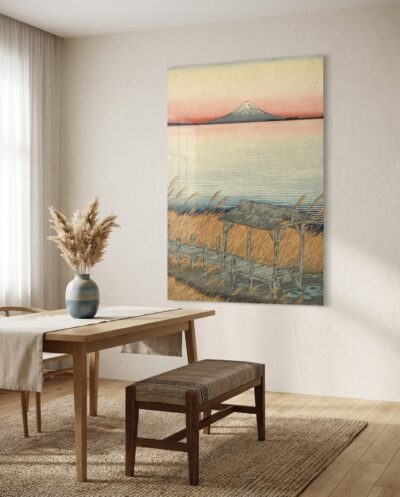 A snow-dusted volcanic peak rises across tranquil waters at first light, framed by whispering golden reeds and a weathered timber pavilion.