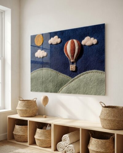 A rust and ecru striped hot air balloon drifts gently over rolling sage hills against a deep indigo sky.