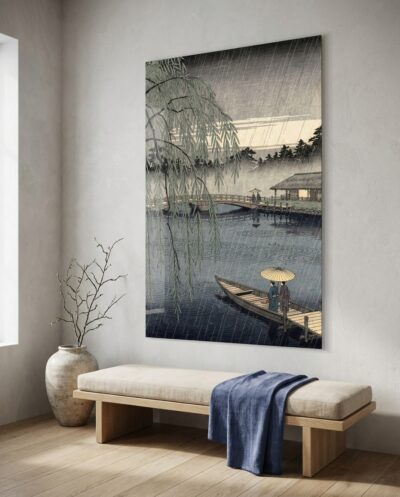 Fine slanting rain sweeps over a mist-veiled river, where cascading willow fronds frame an arched wooden bridge and two travelers sheltered beneath a paper umbrella.